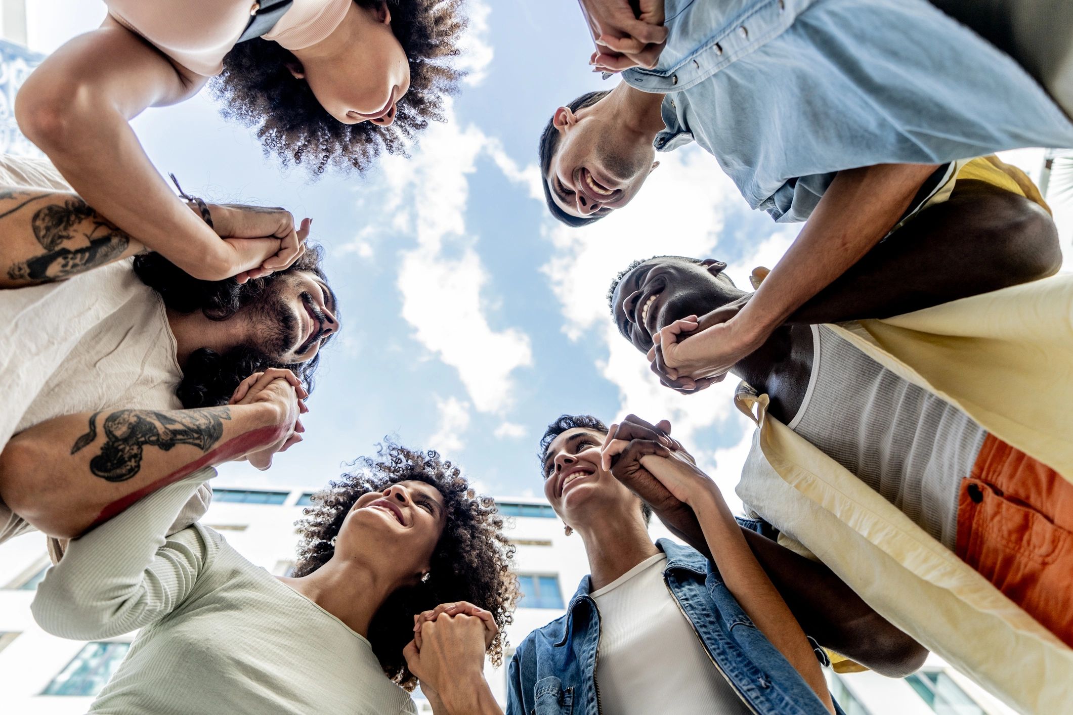 Community members holding hands outdoors